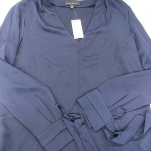 Banana republic size medium navy blue long sleeve blouse with ties at wrists.